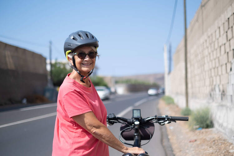 Eine Frau ist glücklich mit ihrem E-Bike