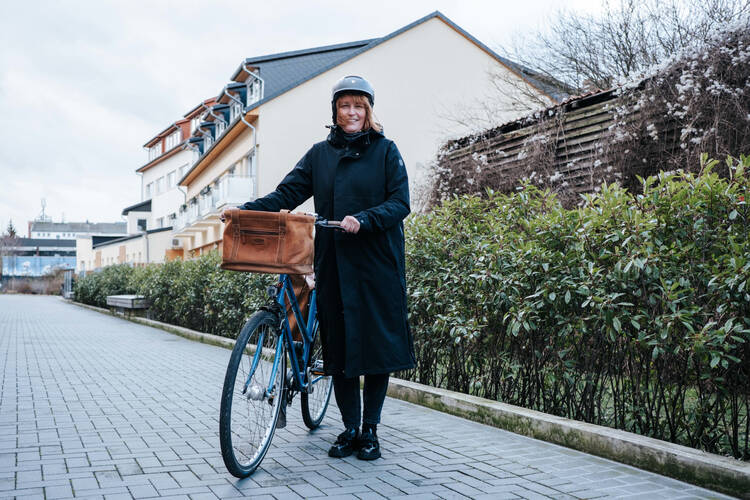 Frau steht mit Ihrem Fahrrad